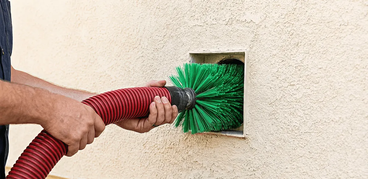 Air duct cleaning brush removing debris from a vent opening in Anchorage, AK