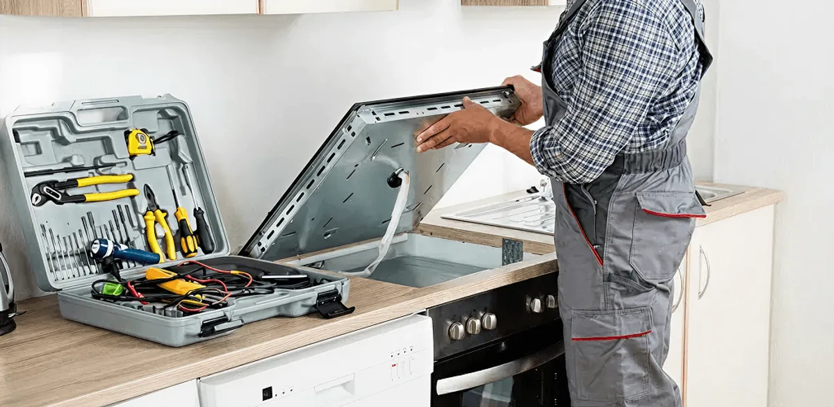 Handyman repairing a cooktop and checking wiring connections in Anchorage, AK