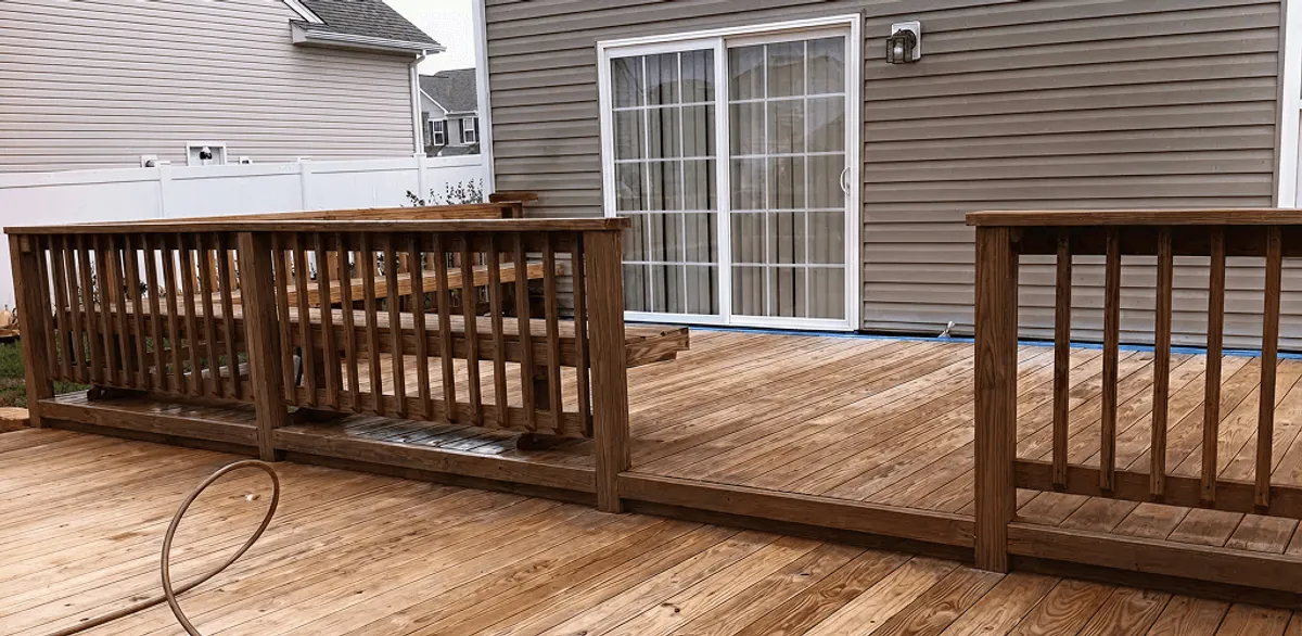 Deck sealing service protecting a backyard wood deck and railings in Anchorage, AK