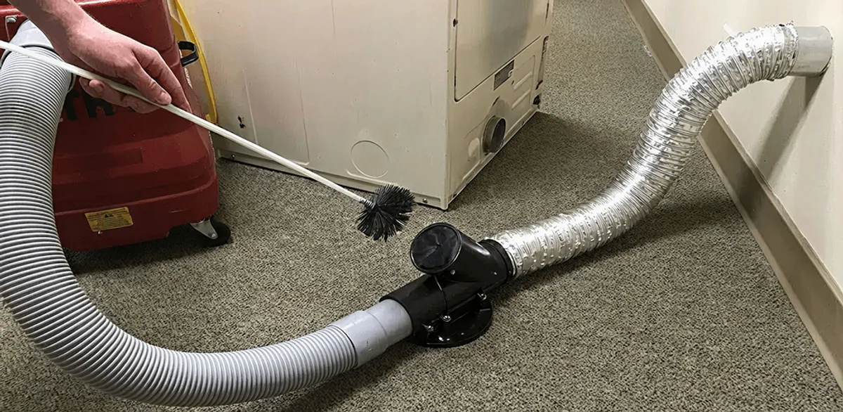 Dryer vent cleaning service removing lint from a dryer duct connection in Anchorage, AK